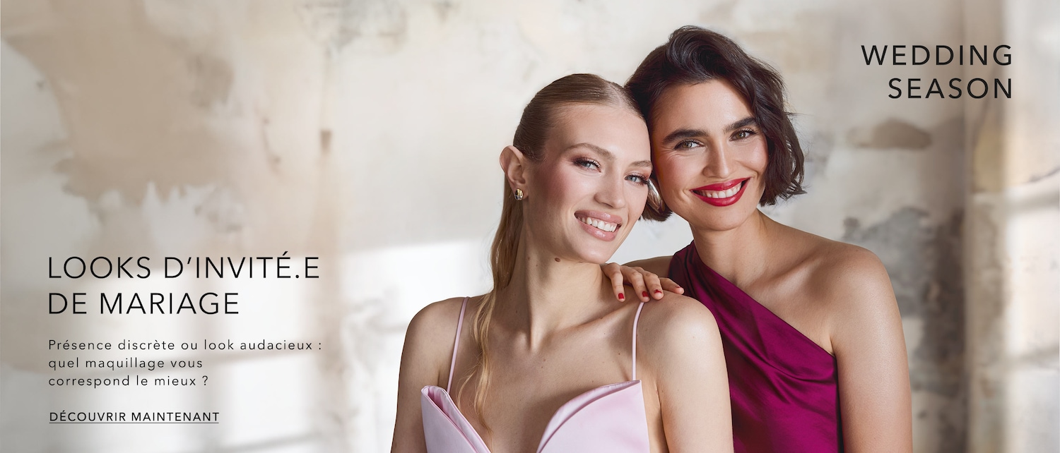 Deux femmes souriantes, l'une en robe rose pâle et l'autre en robe magenta, célèbrent la saison des mariages avec des looks d'invités.